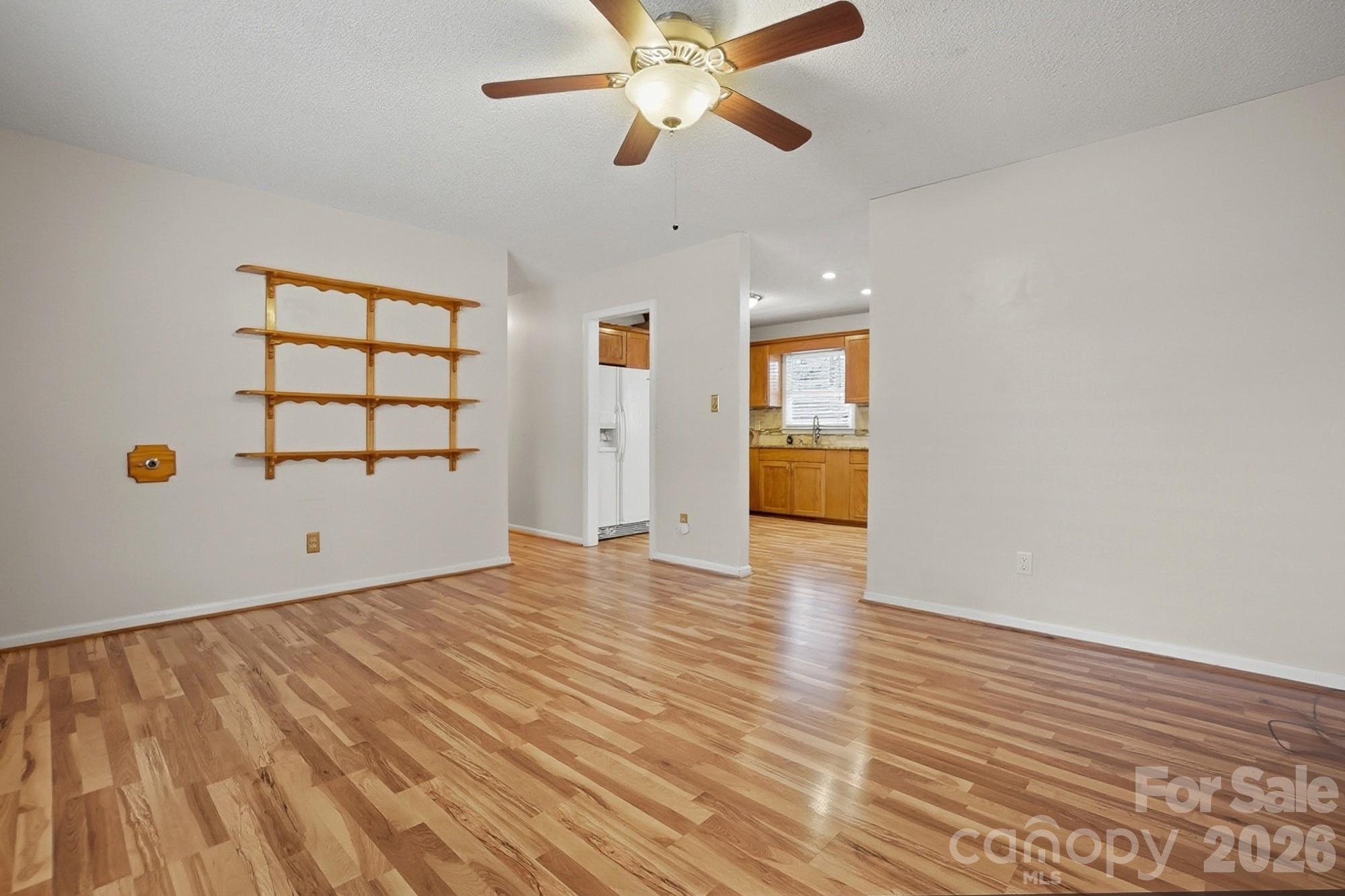 616 Durham Road Stanley, NC 28164 - Photo 5 of 42 a view of empty room with wooden floor and fan