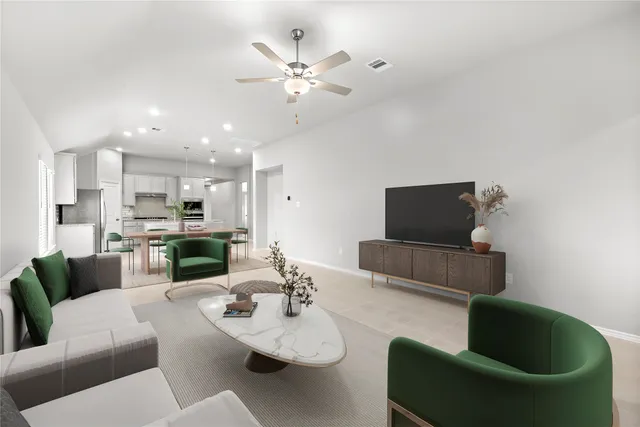 a living room with furniture kitchen view and a chandelier