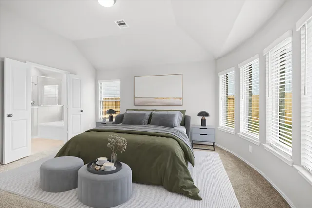 a bedroom with a bed and a large window