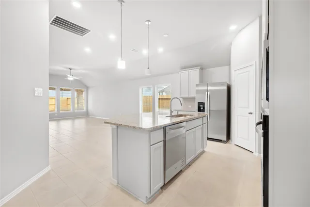 a large kitchen with cabinets and stainless steel appliances