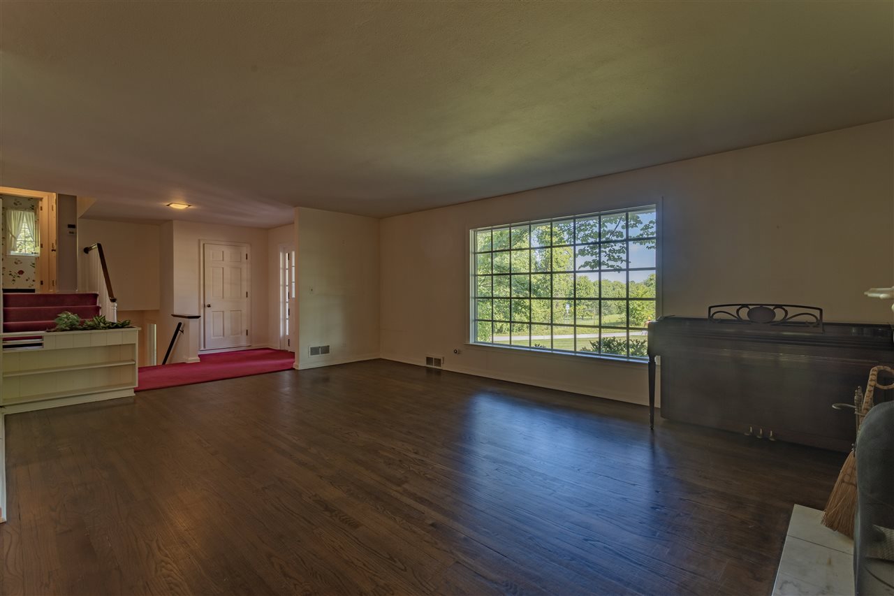 3307 Landstrom Road Rockford, IL 61107 - Photo 18 of 40 a view of empty room with wooden floor and fan