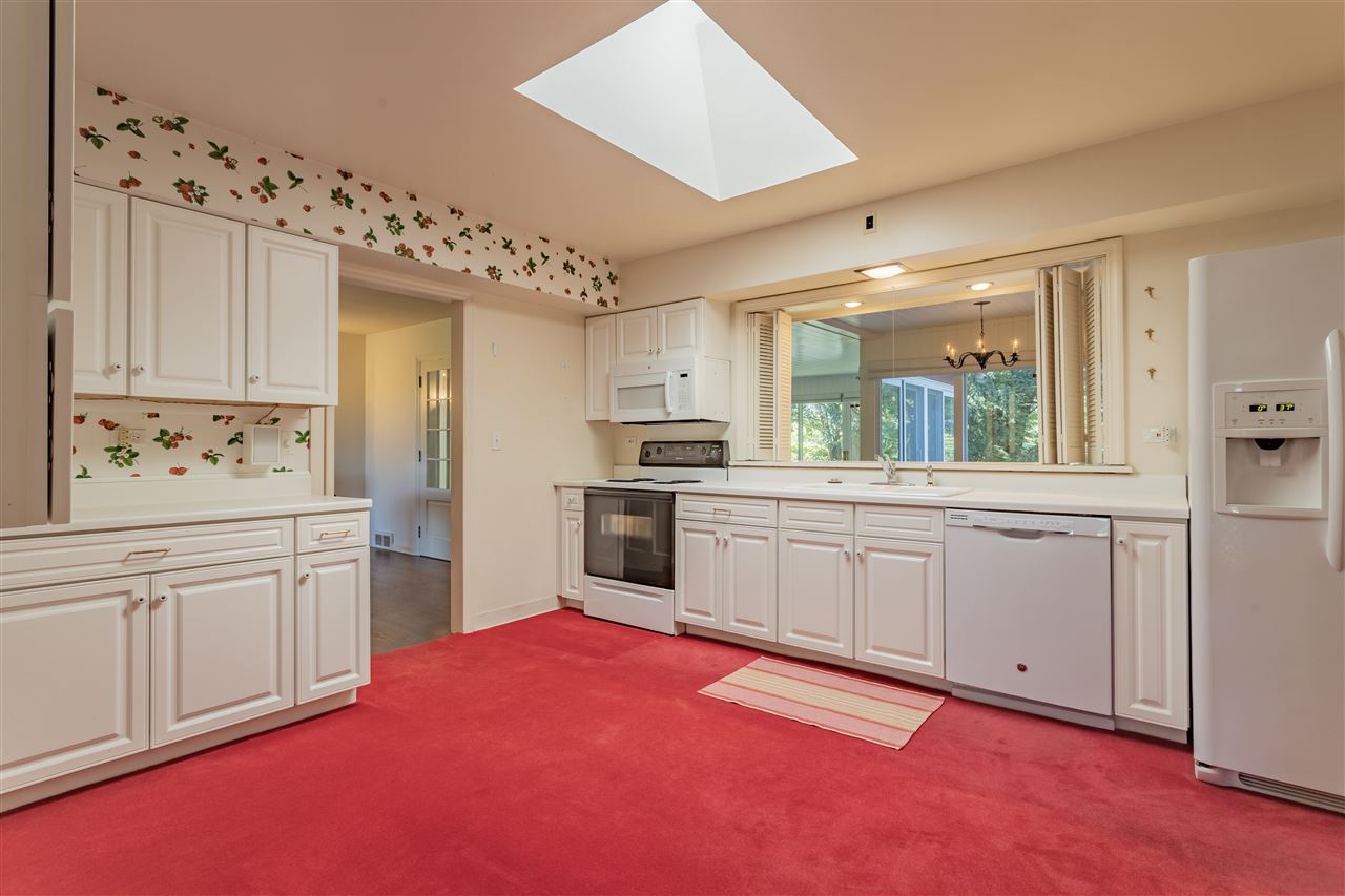 3307 Landstrom Road Rockford, IL 61107 - Photo 21 of 40 a kitchen with granite countertop white cabinets and white appliances