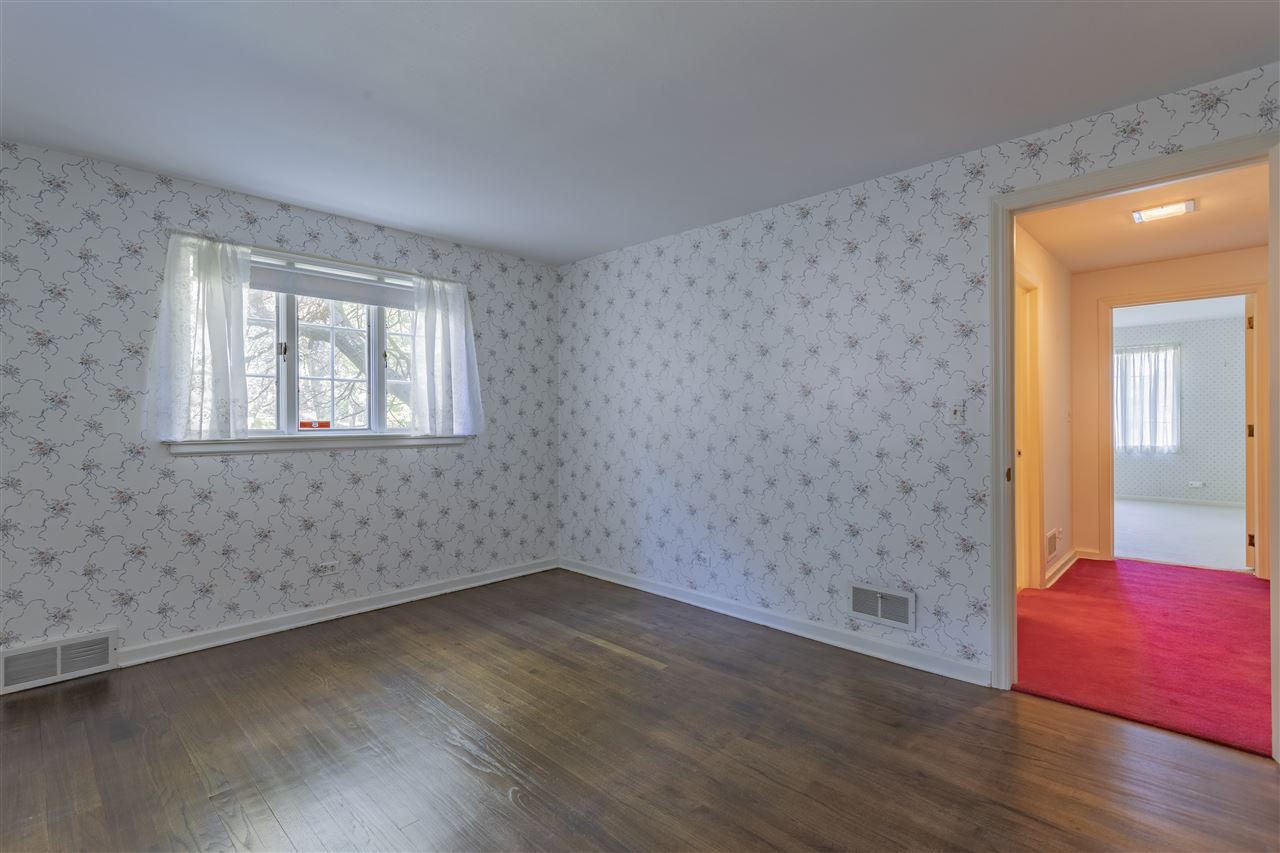3307 Landstrom Road Rockford, IL 61107 - Photo 23 of 40 an empty room with wooden floor and windows