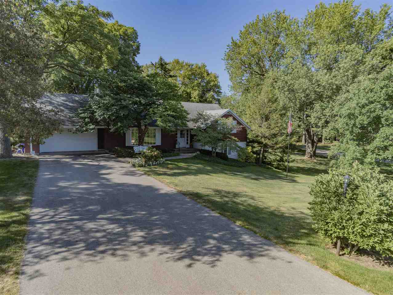 3307 Landstrom Road Rockford, IL 61107 - Photo 3 of 40 a view of a yard with plants and large trees