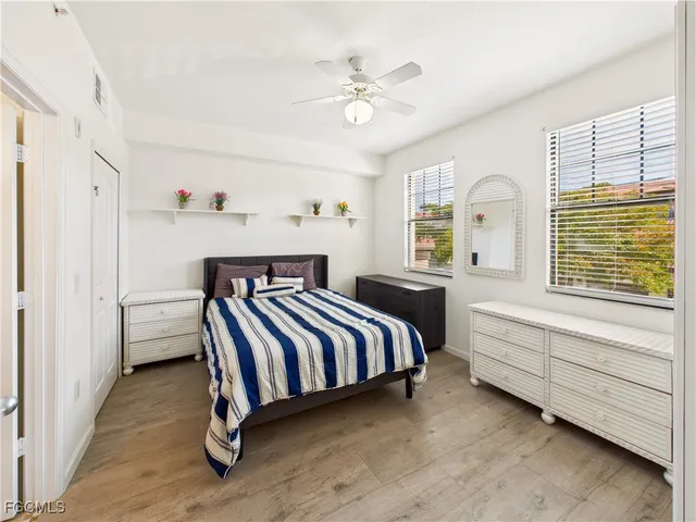 a spacious bedroom with a bed and a window