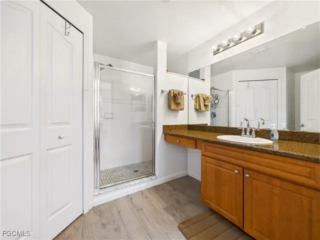 a bathroom with a shower sink and mirror
