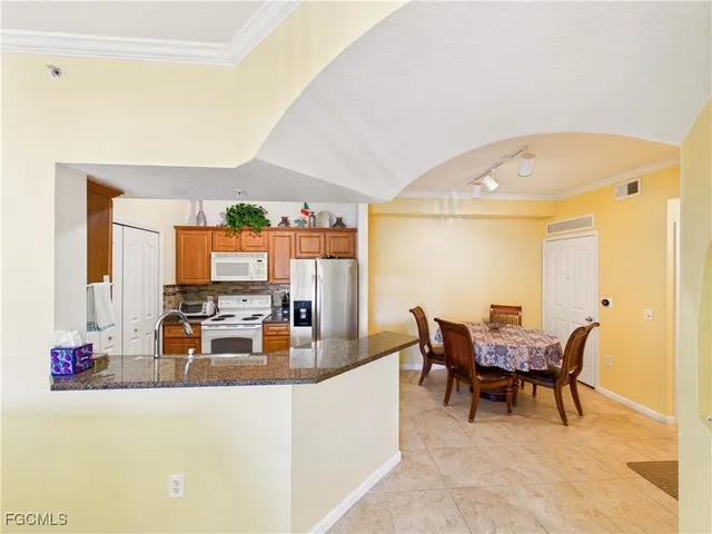 a view of a dining room with furniture and chandelier