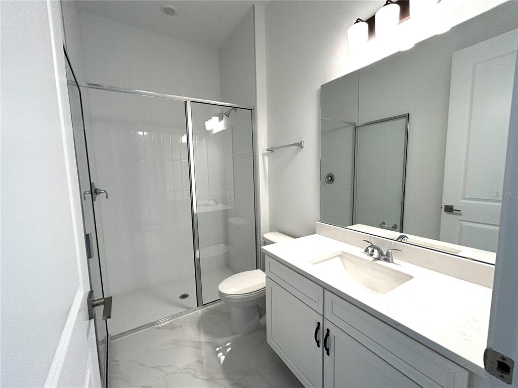 16017 Volterra Point Bella Collina, FL 34756 - Photo 16 of 30 a bathroom with a sink a toilet and shower