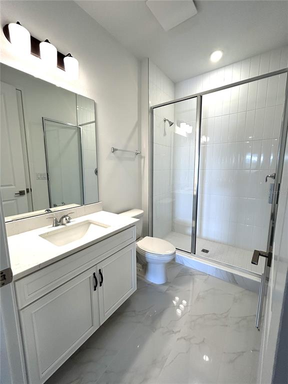 16017 Volterra Point Bella Collina, FL 34756 - Photo 22 of 30 a bathroom with a double vanity sink toilet and shower