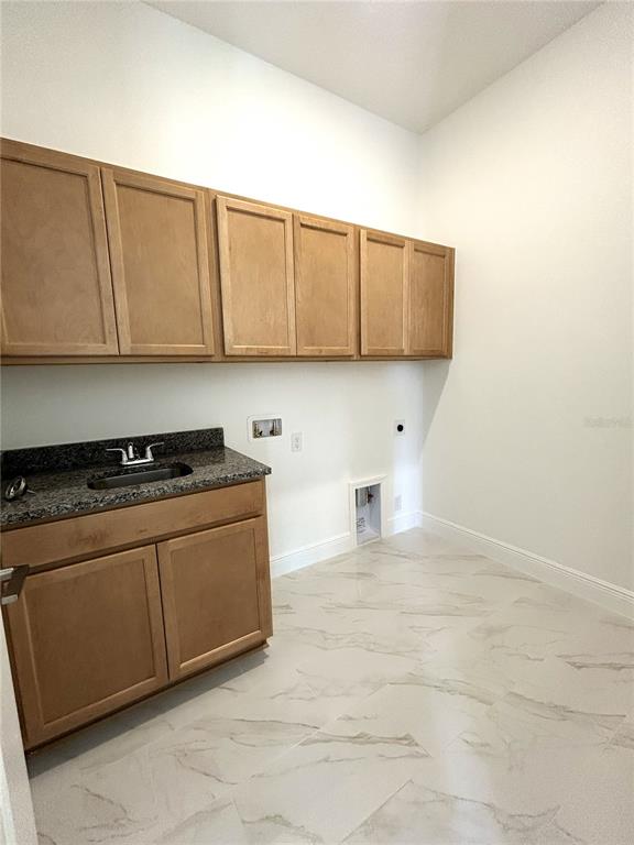 16017 Volterra Point Bella Collina, FL 34756 - Photo 28 of 30 a kitchen with a stove and a white cabinets