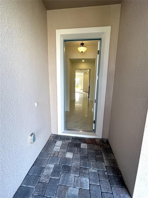 16017 Volterra Point Bella Collina, FL 34756 - Photo 5 of 30 a view of a hallway with wooden door