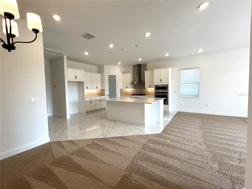 16017 Volterra Point Bella Collina, FL 34756 - Photo 8 of 30 a view of kitchen with kitchen island microwave and cabinets