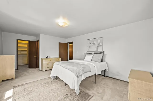 a bedroom with a large bed and a couch