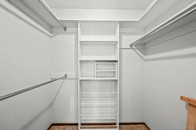 a view of walk in closet with empty racks