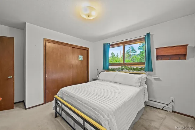 a bedroom with a large bed and a window