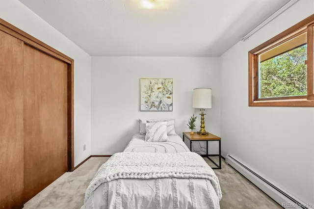 a bedroom with a bed and window