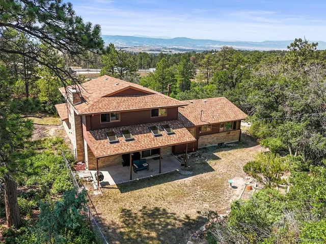 a view of a terrace with a table and chairs under an umbrella