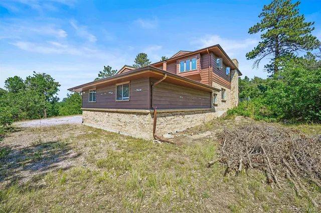 a house that has a tree in front of it