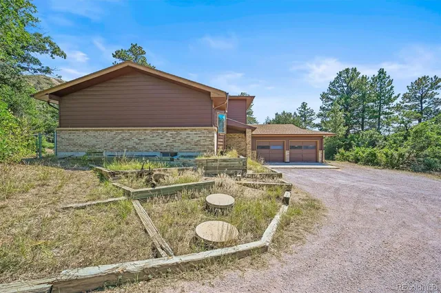 a table and chairs sitting in the backyard of the house