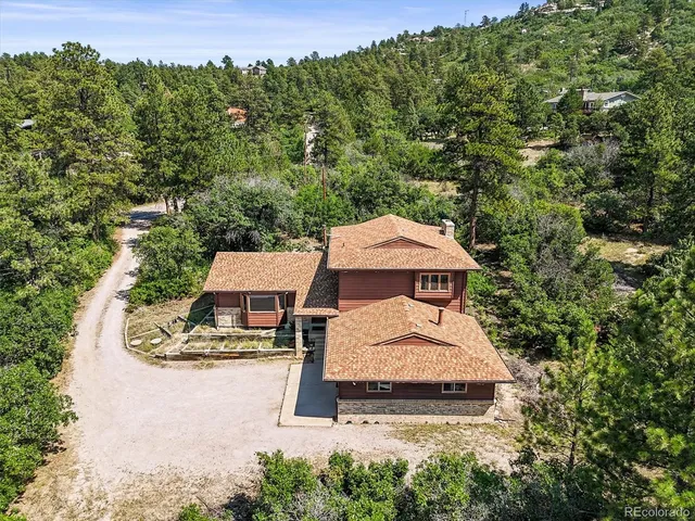 an aerial view of a house with yard swimming pool and outdoor seating