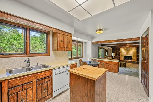 a kitchen that has a sink and a stove in it