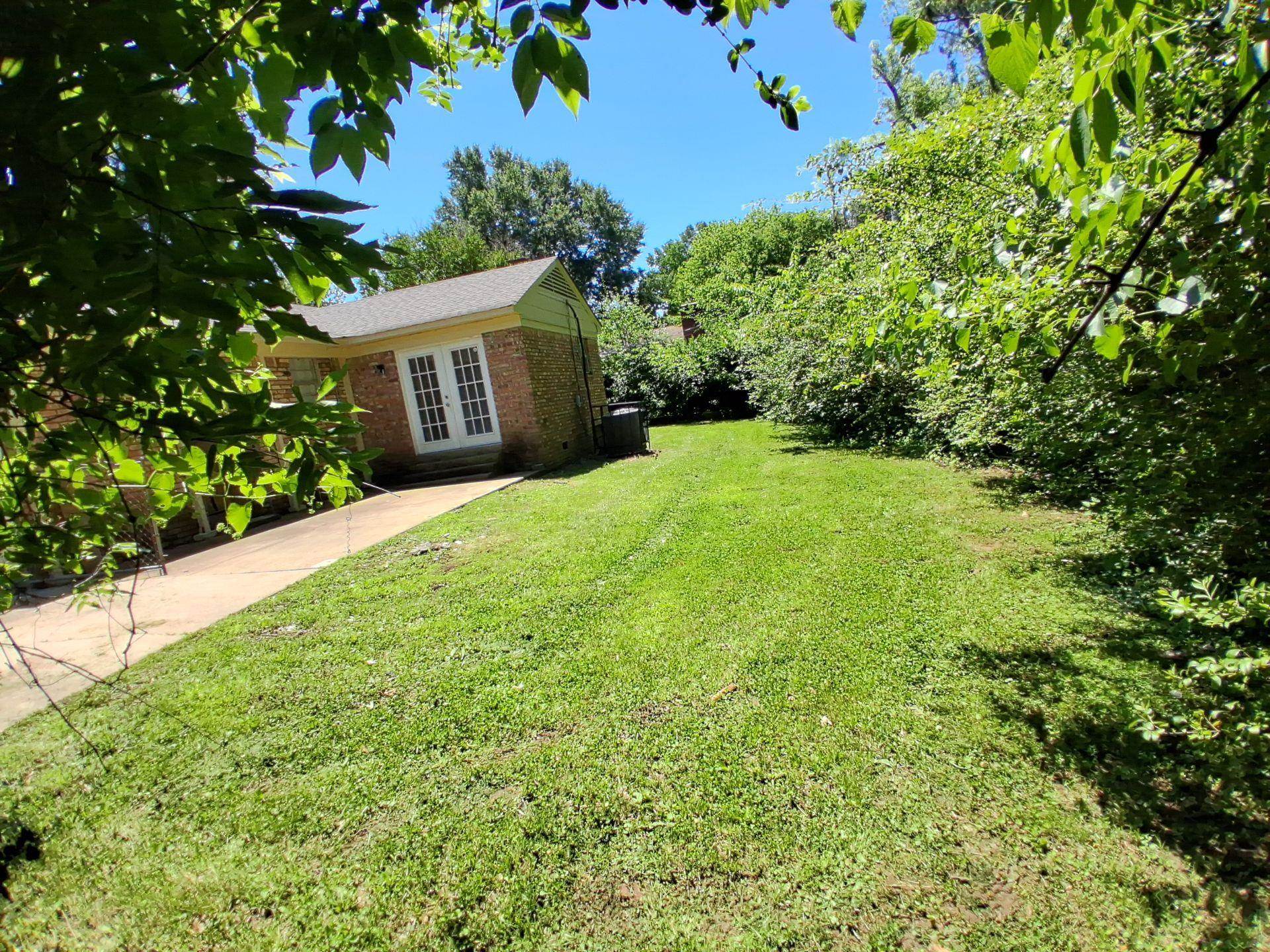 3853 Range Line Road Memphis, TN 38127 - Photo 17 of 18 View of grassy yard with french doors