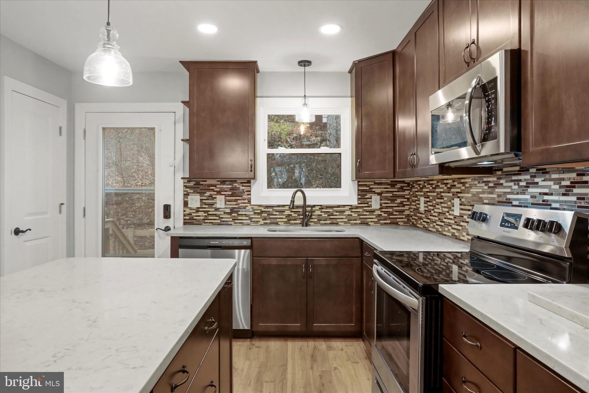 401 Bragg Drive Front Royal, VA 22630 - Photo 13 of 50 a kitchen with stainless steel appliances granite countertop a sink stove and refrigerator