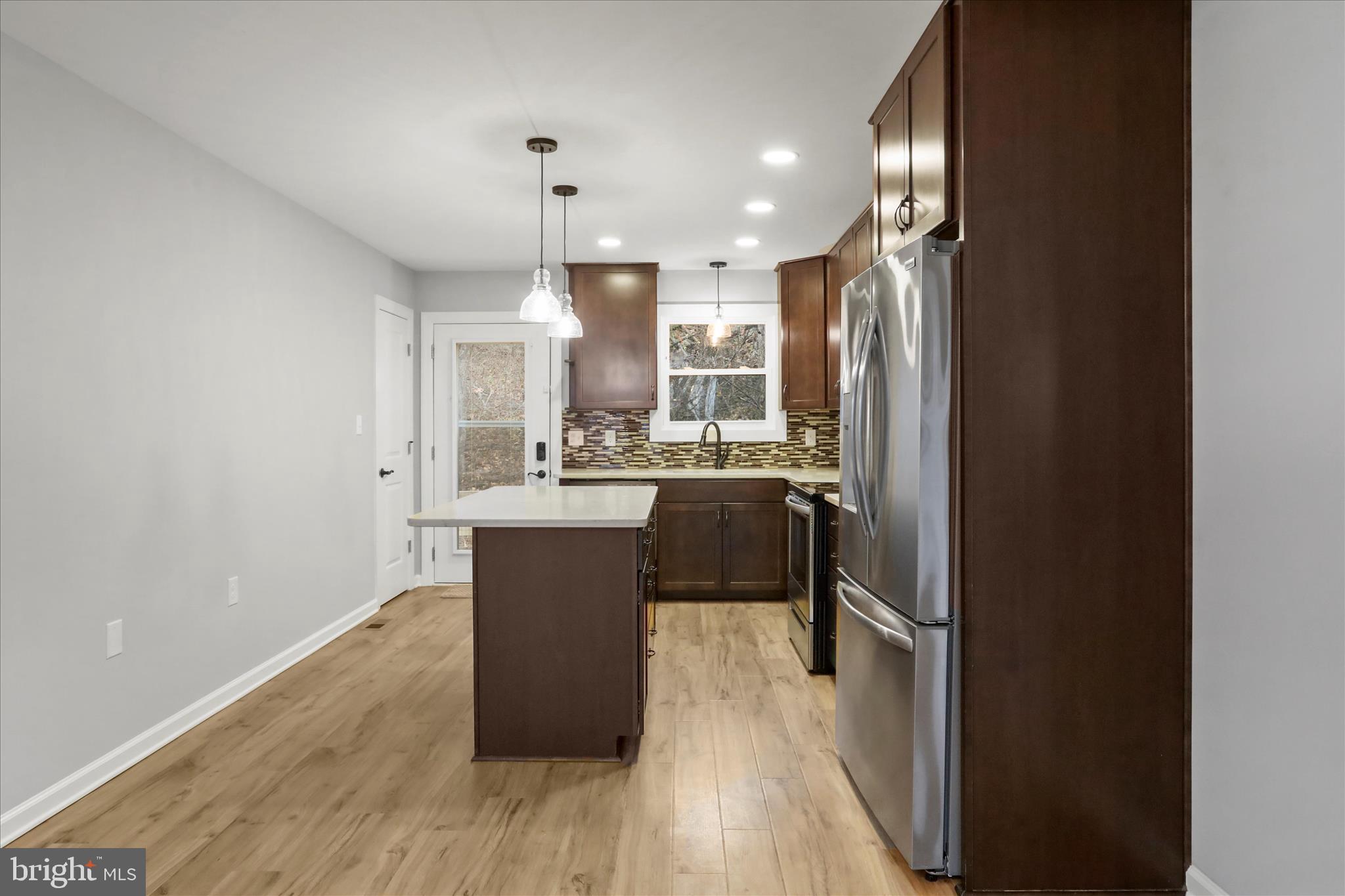 401 Bragg Drive Front Royal, VA 22630 - Photo 14 of 50 a kitchen with kitchen island a sink appliances and cabinets