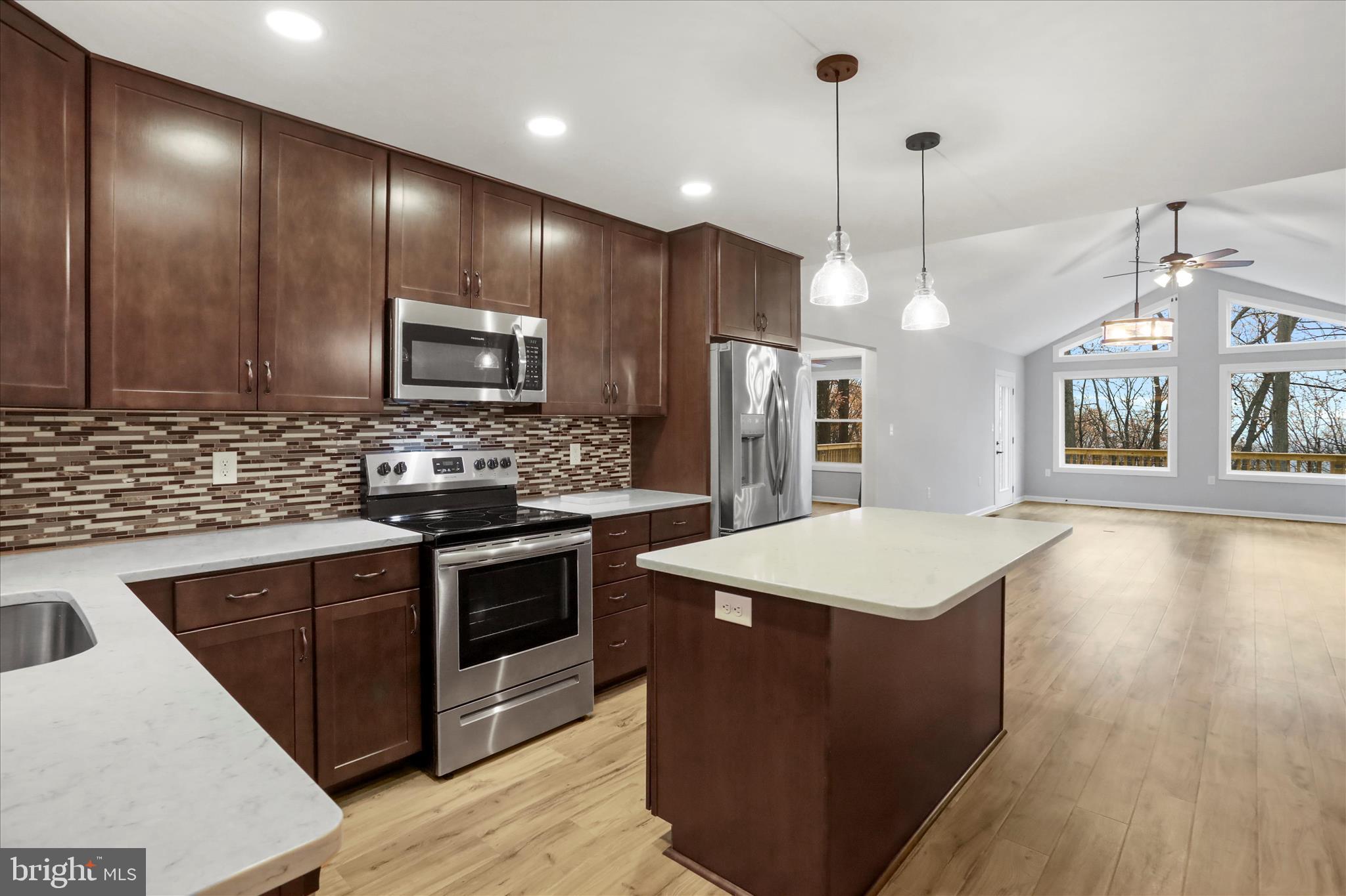 401 Bragg Drive Front Royal, VA 22630 - Photo 16 of 50 a kitchen with kitchen island a sink stainless steel appliances and cabinets