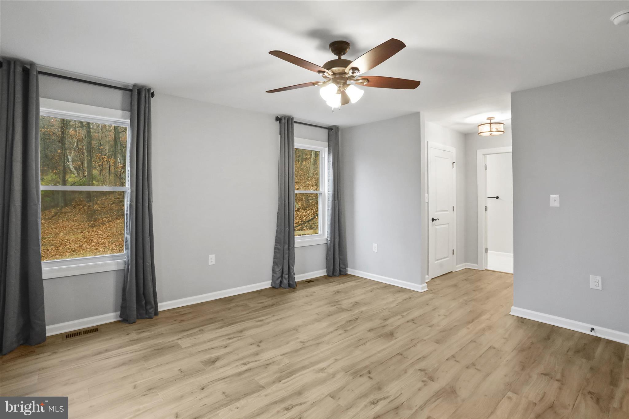 401 Bragg Drive Front Royal, VA 22630 - Photo 20 of 50 a view of an empty room with wooden floor and a window