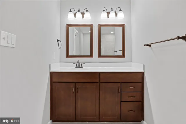 a bathroom with a sink vanity and mirror