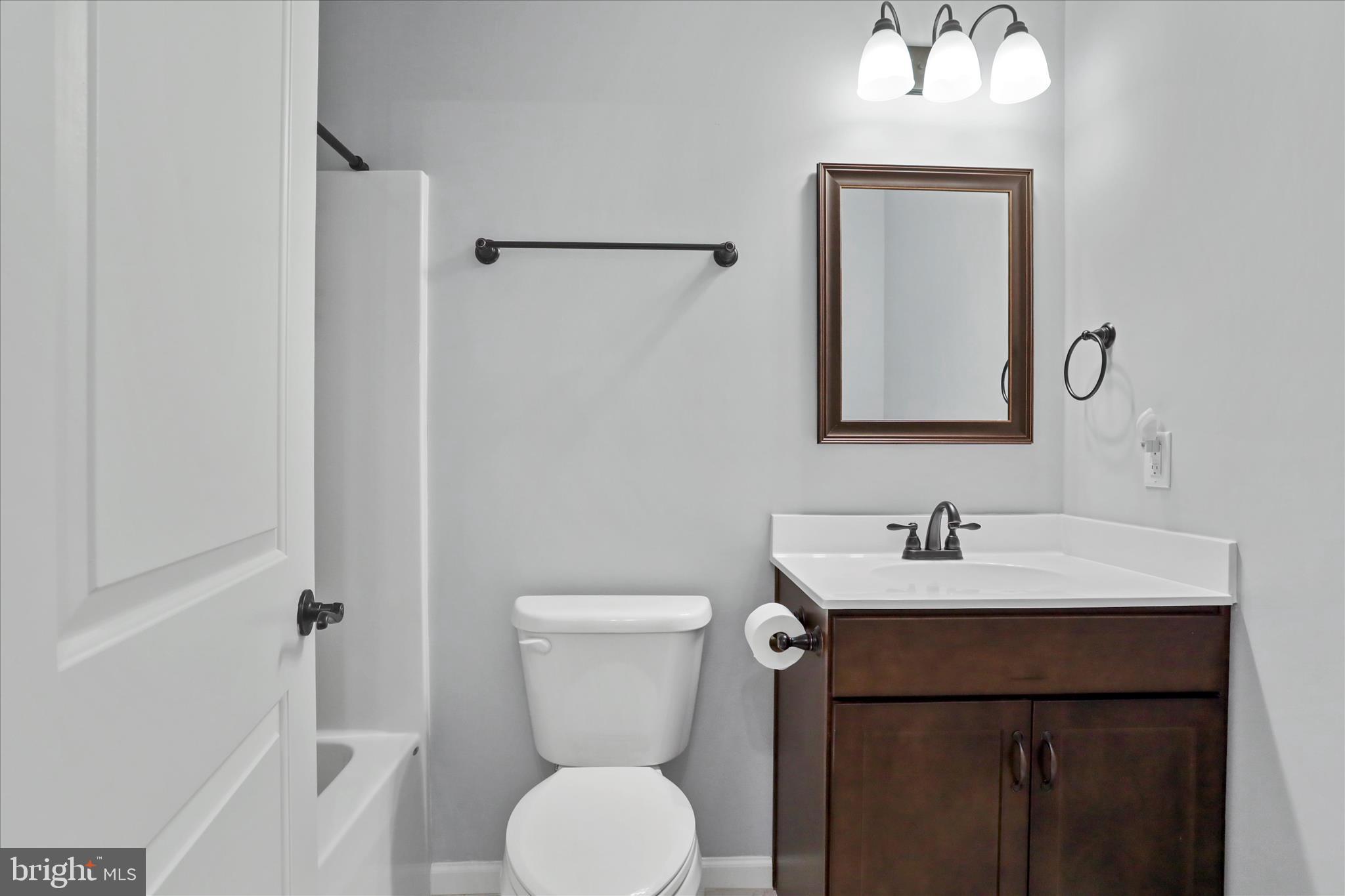 401 Bragg Drive Front Royal, VA 22630 - Photo 27 of 50 a bathroom with a toilet a sink and mirror