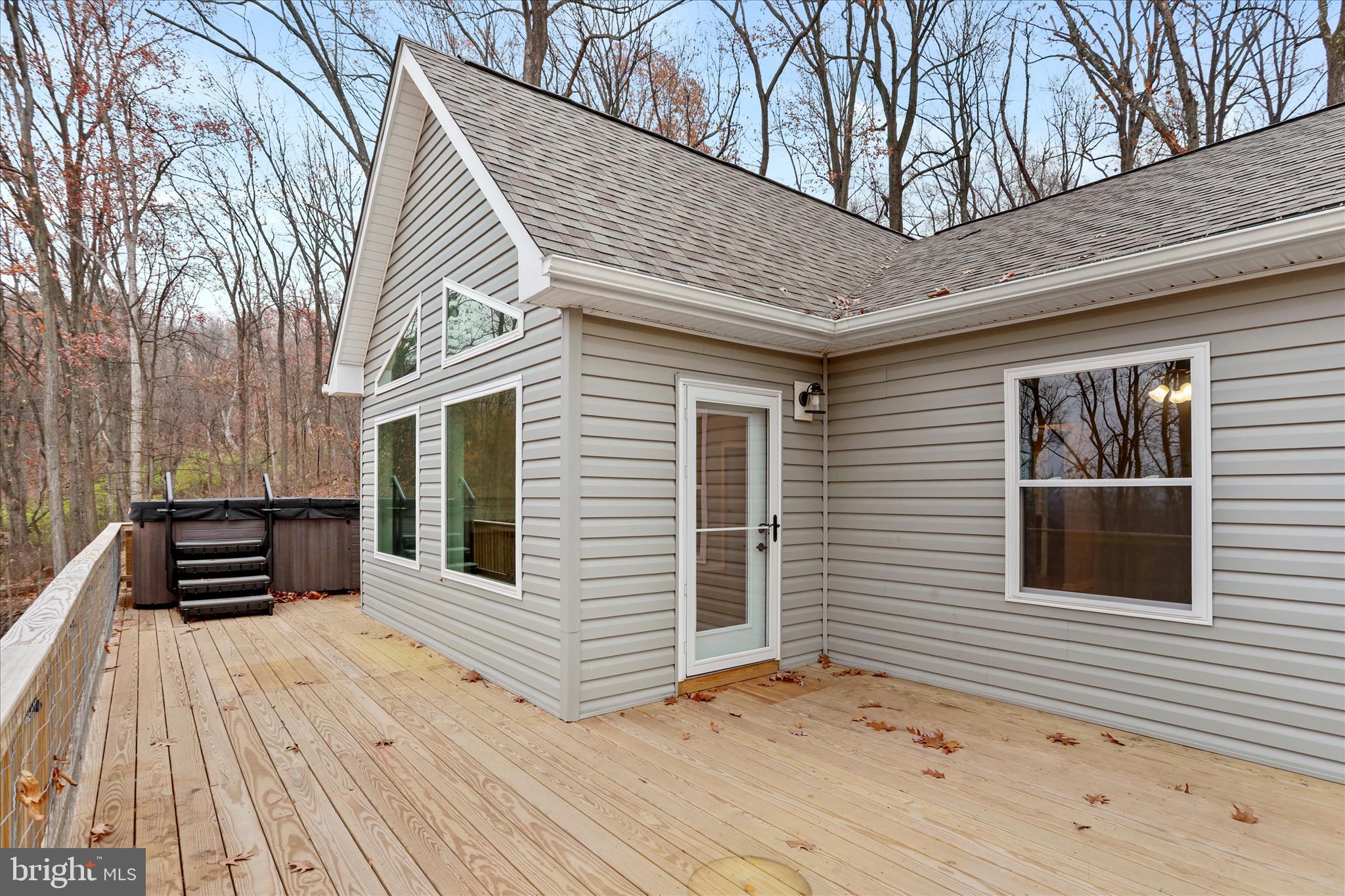 401 Bragg Drive Front Royal, VA 22630 - Photo 36 of 50 a backyard of a house with wooden floor and fence