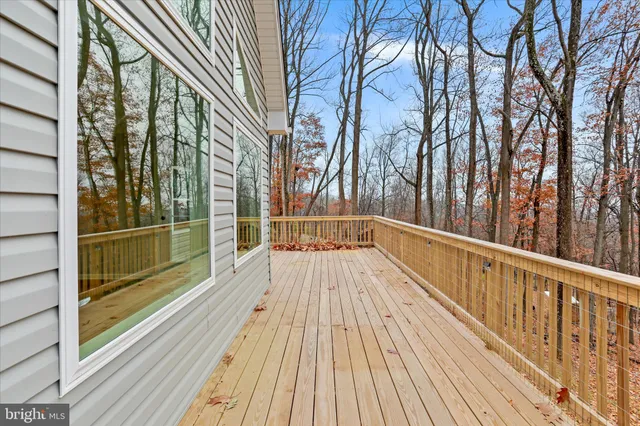 a view of balcony with a large window and wooden floor