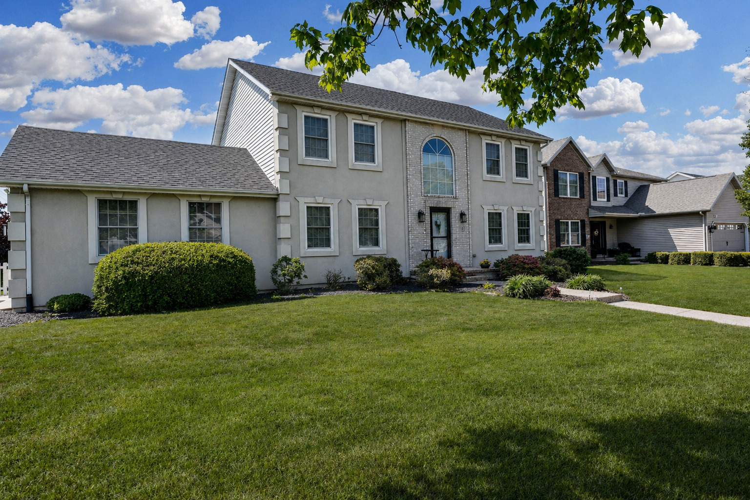 a front view of a house with a garden