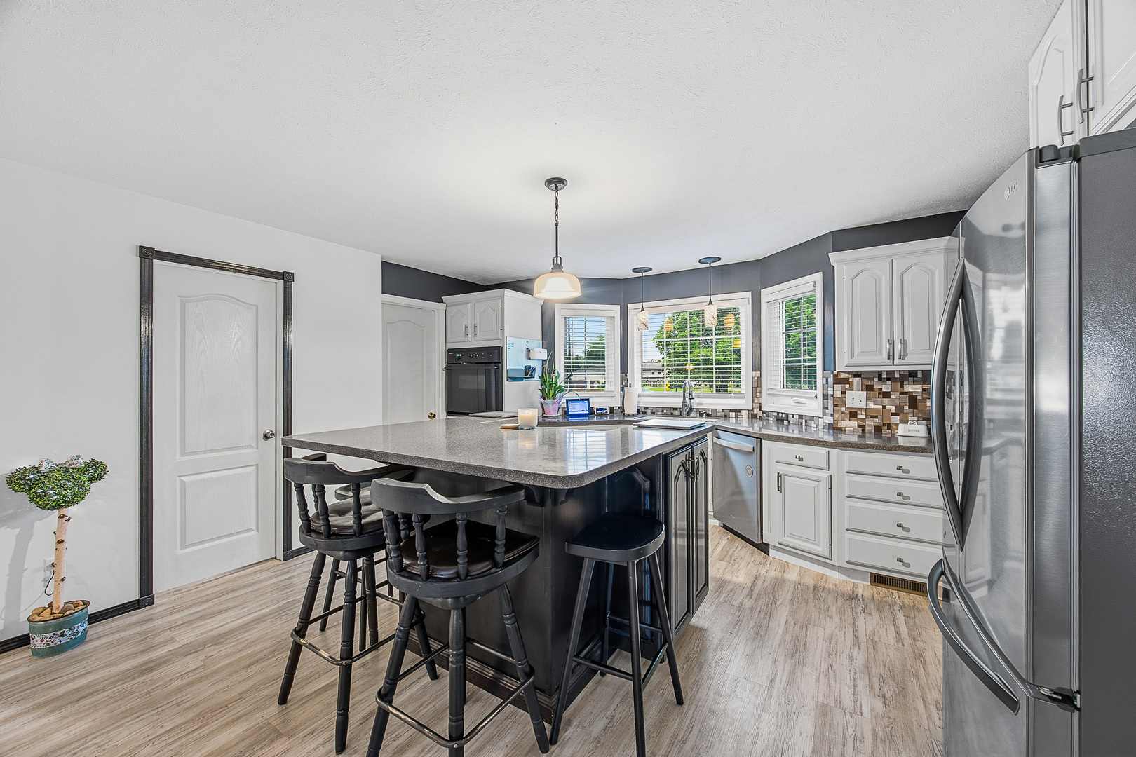 2 Bandecon Way Bloomington, IL 61704 - Photo 13 of 45 a kitchen with stainless steel appliances granite countertop a kitchen island a stove a table and chairs in it