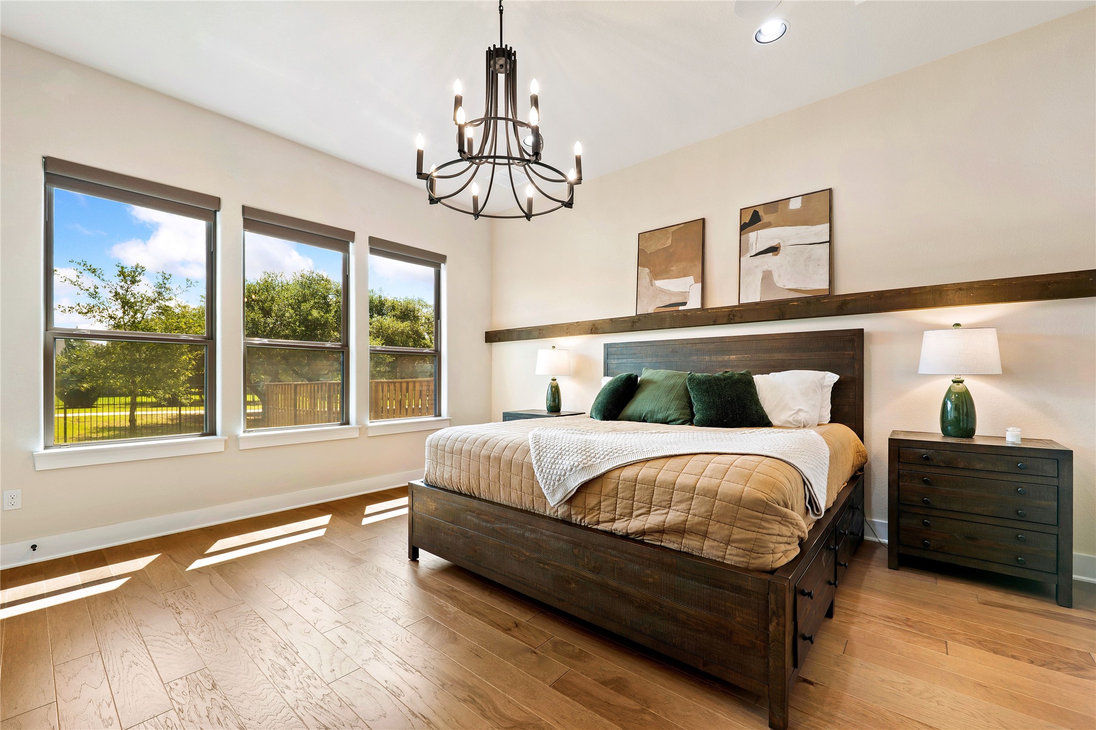 2408 Nate's Place Georgetown, TX 78633 - Photo 16 of 40 Hardwood floors and generous windows elevate this naturally illuminated primary bedroom.