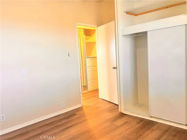 an empty room with wooden floor and a window