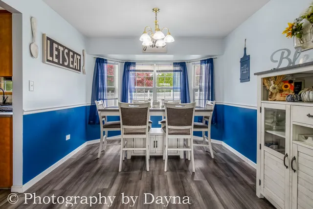 a dining room with furniture a rug and a chandelier