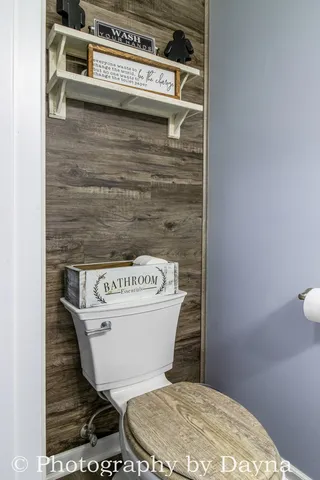 a toilet sitting on top of a wooden floor