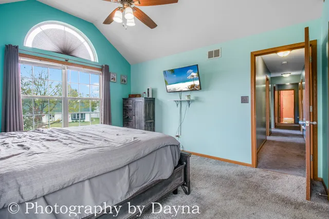 a bedroom with a bed and a mirror