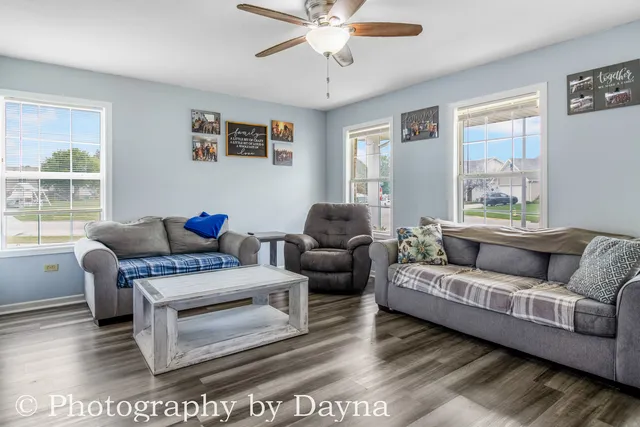 a living room with furniture and a large window