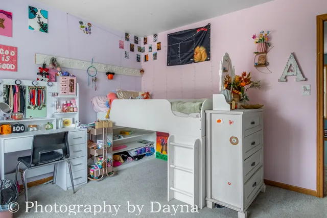 a utility room with fridge and a couch