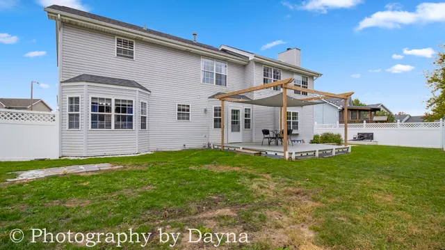 a view of a house with a yard and sitting area