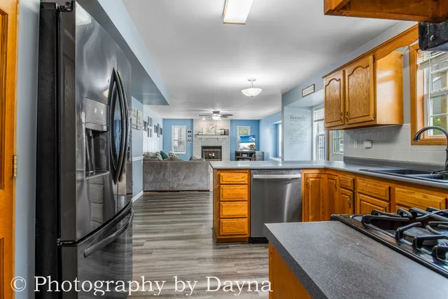 a kitchen with stainless steel appliances granite countertop a refrigerator and a sink
