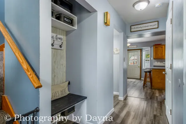a view of entryway and hall with wooden floor