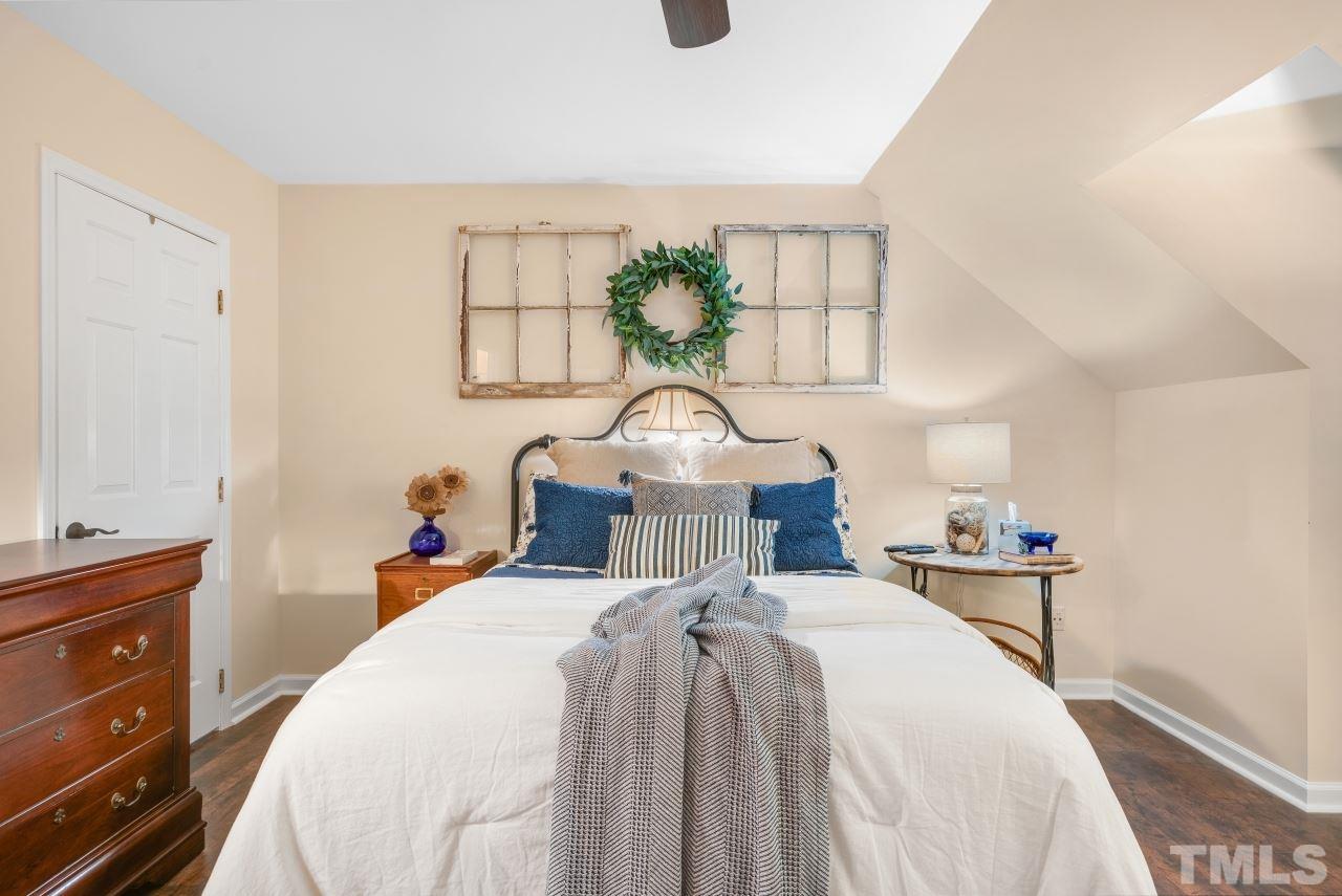 1720 Township Circle Raleigh, NC 27609 - Photo 14 of 27 a bedroom with a bed and a chandelier