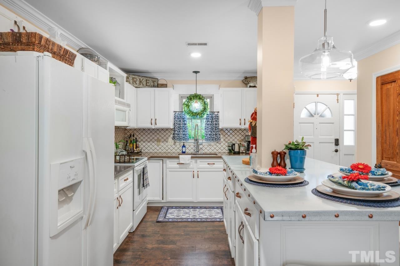 1720 Township Circle Raleigh, NC 27609 - Photo 8 of 27 a kitchen with sink refrigerator and cabinets