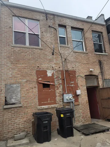 a brick building with a black door