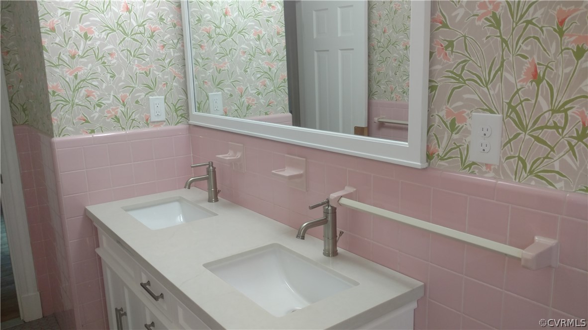 8316 Abbey Road Richmond, VA 23235 - Photo 12 of 15 a bathroom with a sink and a mirror